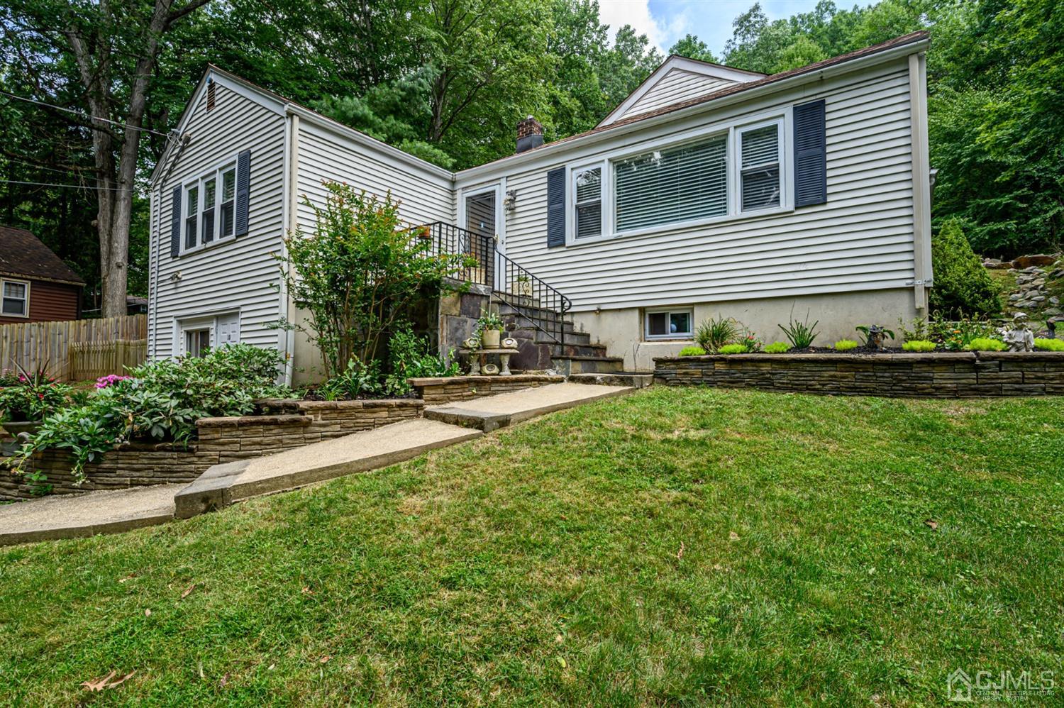 10 Stiles Road Warren, NJ 07059 - Photo 38 of 39 a front view of a house with a yard and outdoor seating