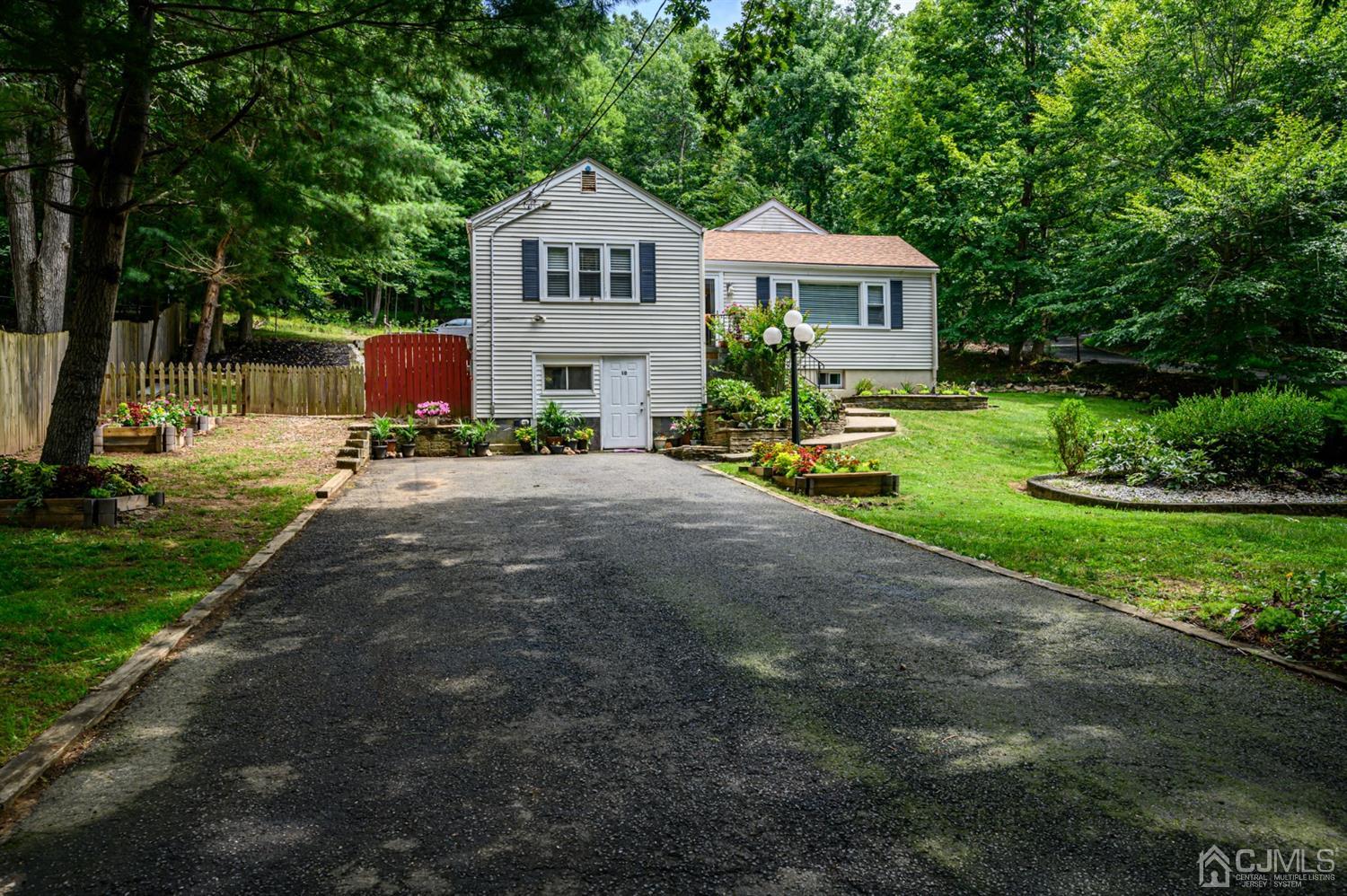 10 Stiles Road Warren, NJ 07059 - Photo 39 of 39 a front view of a house with a garden and trees