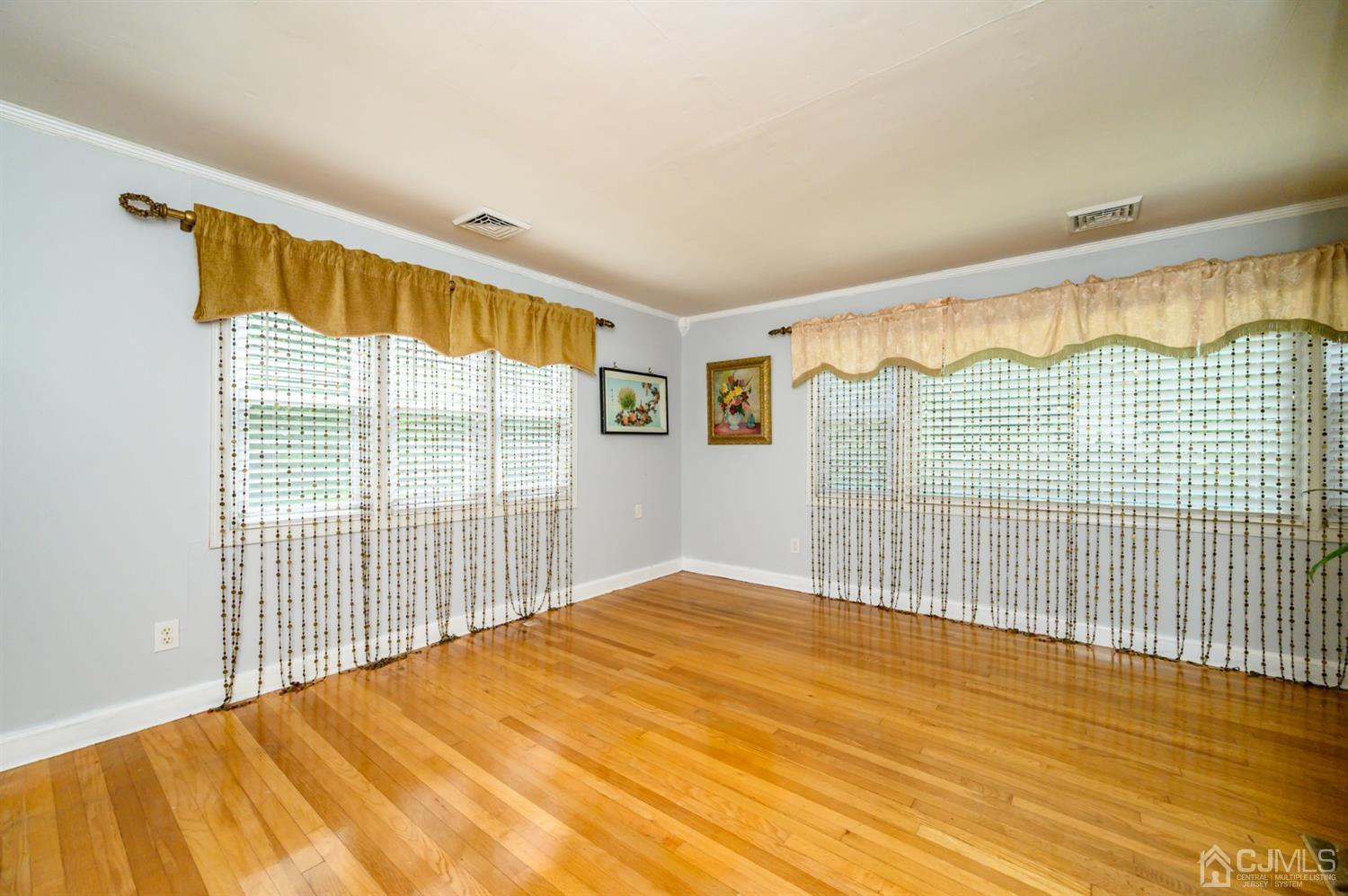 10 Stiles Road Warren, NJ 07059 - Photo 8 of 39 a view of empty room with wooden floor and fan