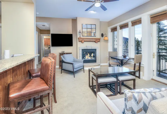 a living room with furniture a flat screen tv and a fireplace