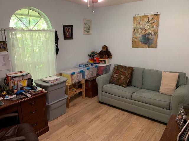 6325 Salado Road St. Augustine, FL 32080 - Photo 17 of 28 a living room with furniture a fireplace and a large window