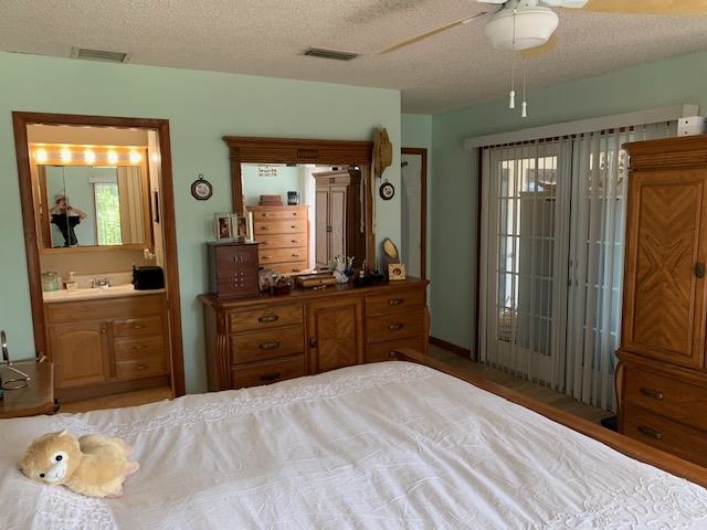 6325 Salado Road St. Augustine, FL 32080 - Photo 19 of 28 a bedroom with a bed and a mirror