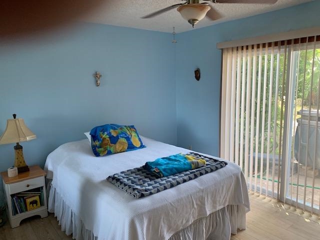 6325 Salado Road St. Augustine, FL 32080 - Photo 20 of 28 a bedroom with a bed and a chandelier