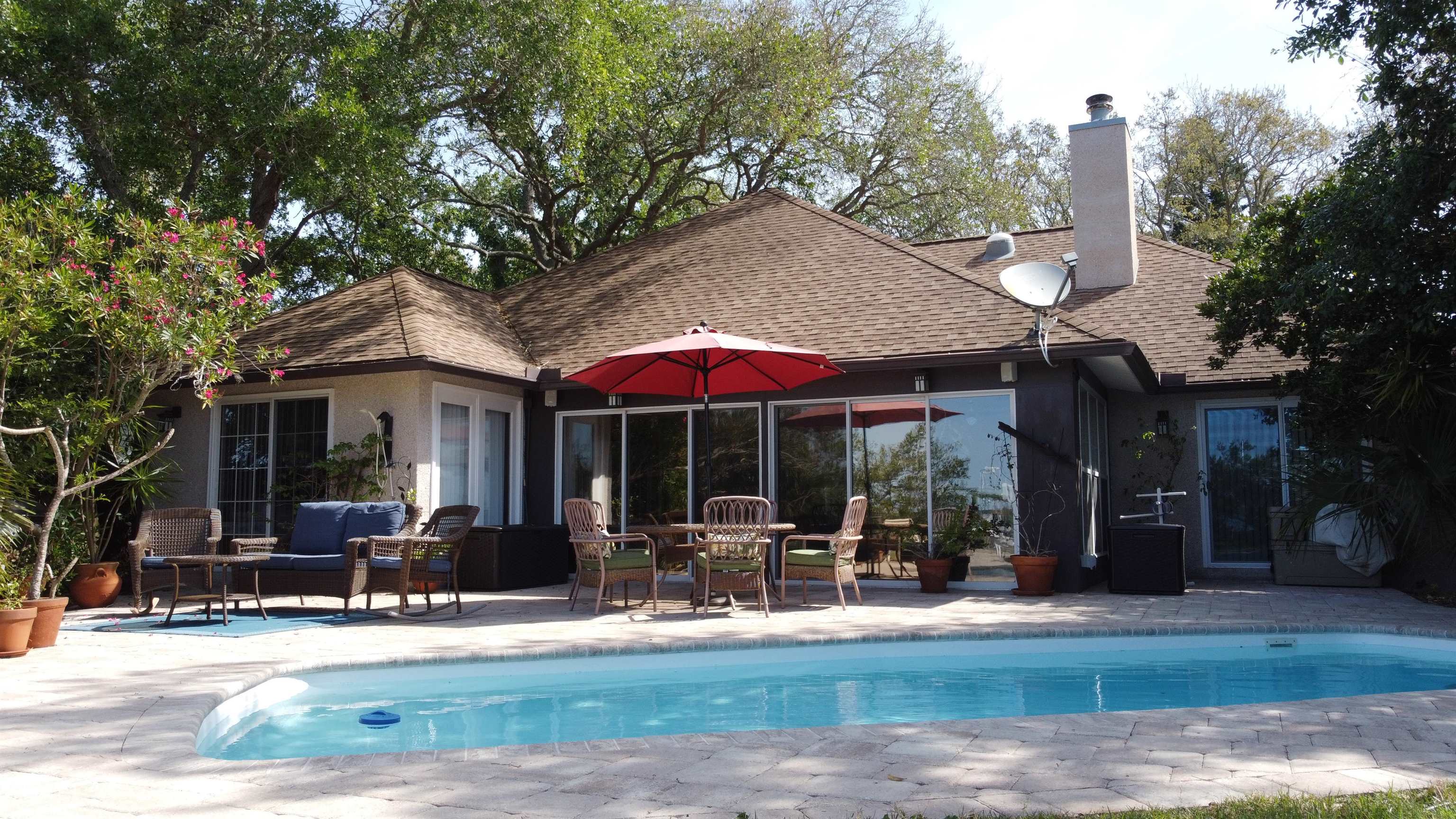 6325 Salado Road St. Augustine, FL 32080 - Photo 9 of 28 a view of a patio with table and chairs under an umbrella