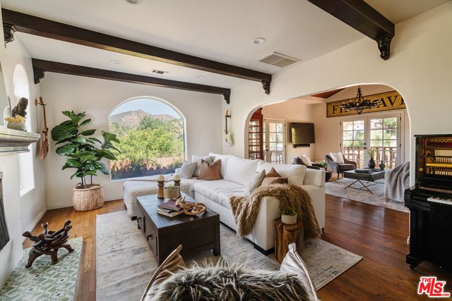 a living room with furniture fireplace and potted plants