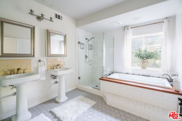 a bathroom with a bathtub and a sink