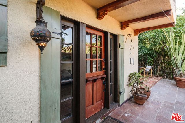 a view of a house with potted plants