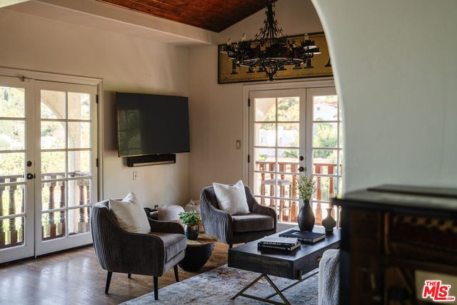 a living room with furniture tv and a window