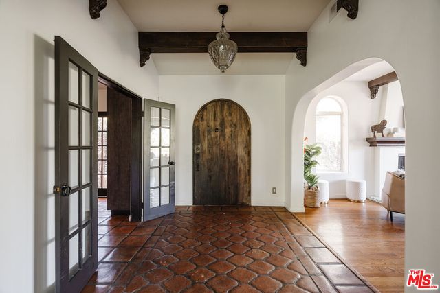 a view of hall way with wooden floor and staircase