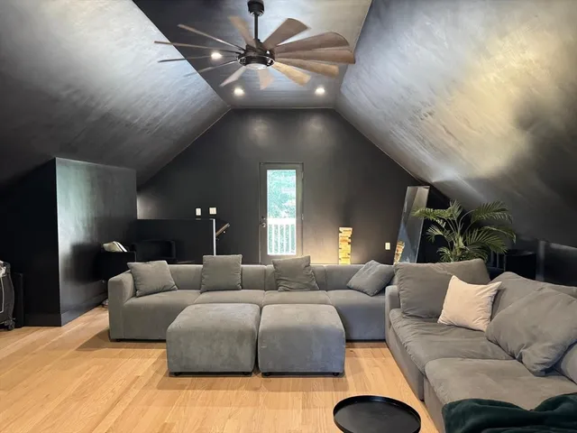 a bedroom with furniture and a ceiling fan