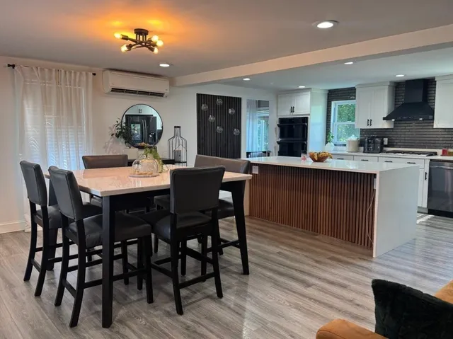 a view of a dining room with furniture and wooden floor