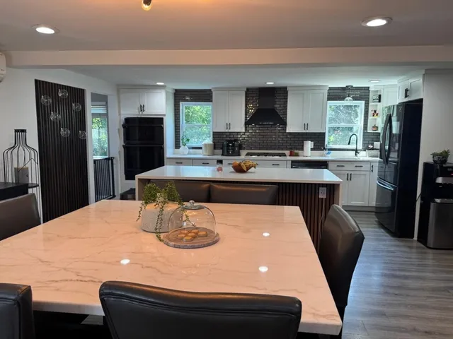 a view of a dining room with furniture and wooden floor