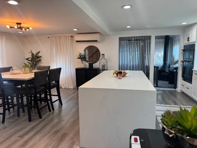 a dining room with furniture and wooden floor