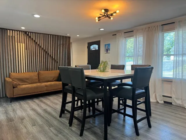 a view of a dining room with furniture window and wooden floor