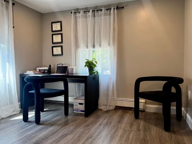 a workspace with furniture and wooden floor