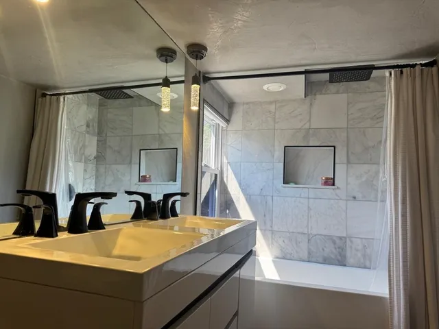 a bathroom with a double vanity sink and mirror