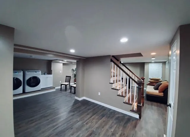 a view of a livingroom with furniture and hardwood floor