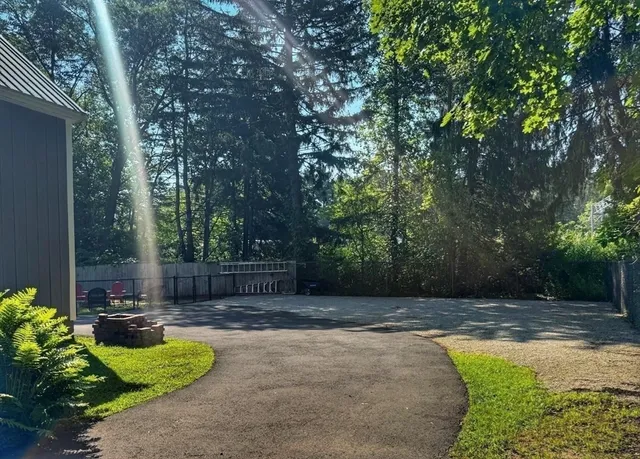 a swimming pool with outdoor seating and yard