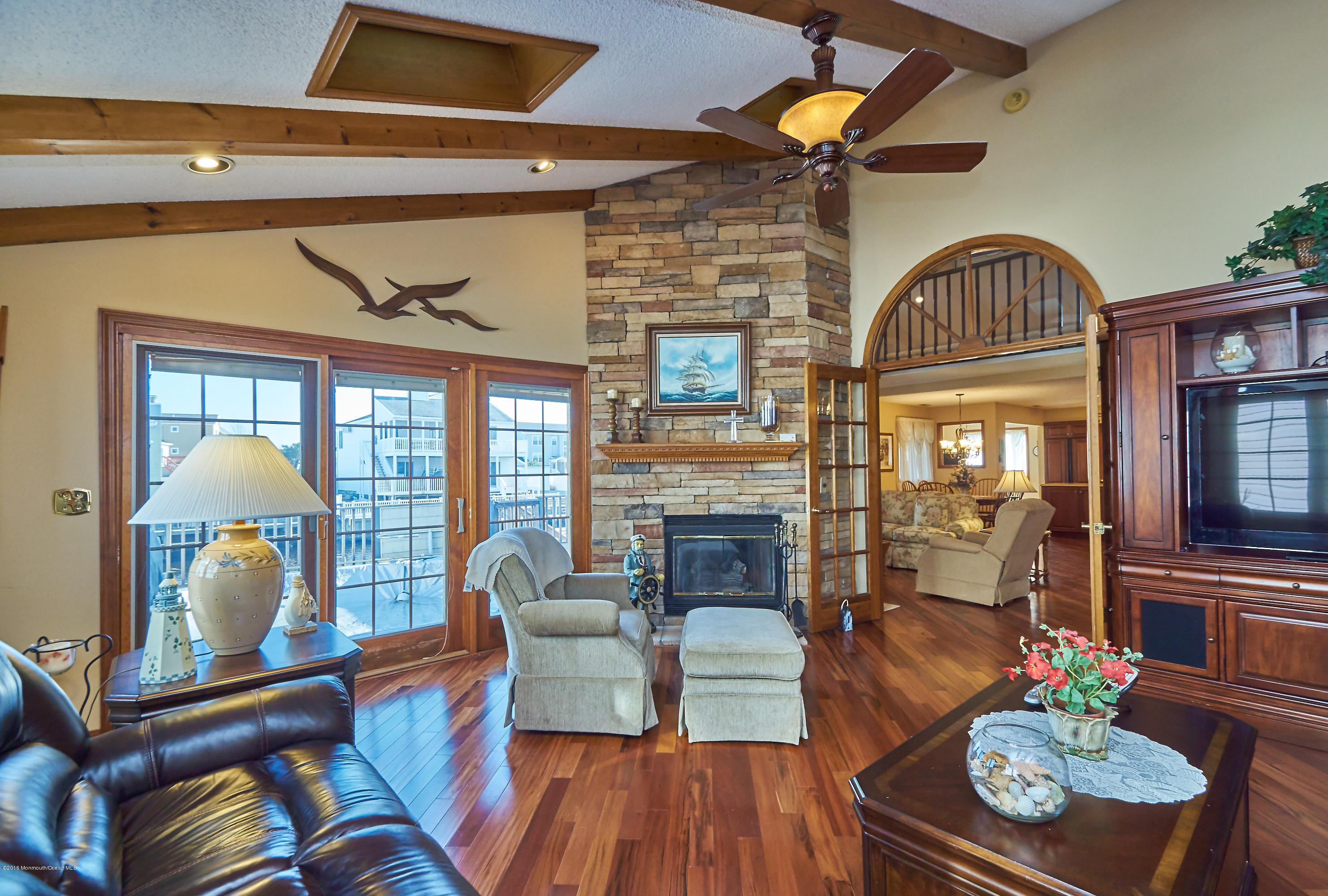 132 Peter Road Manahawkin, NJ 08050 - Photo 18 of 36 a living room with furniture a fireplace and a dining table