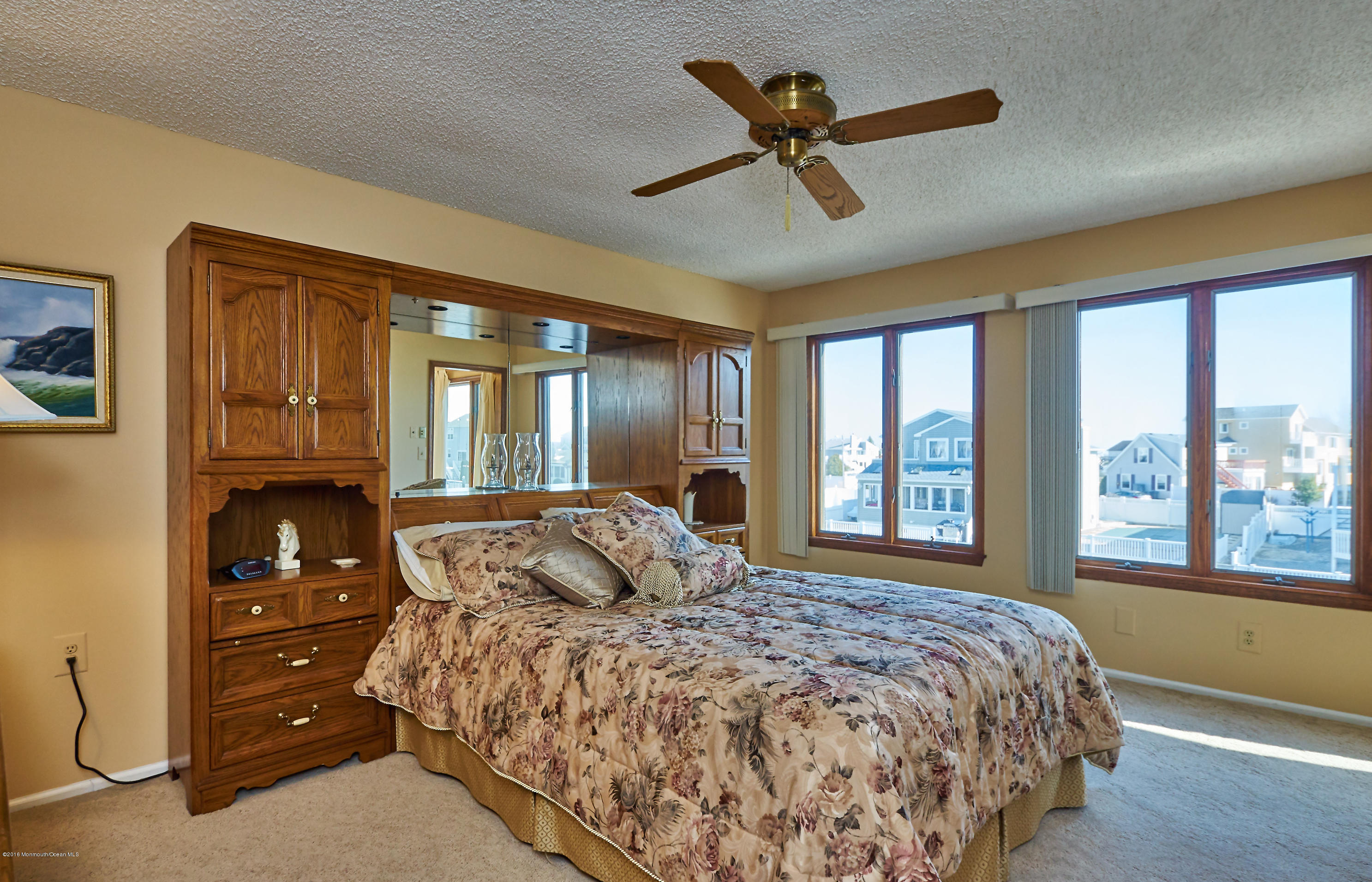 132 Peter Road Manahawkin, NJ 08050 - Photo 26 of 36 a bedroom with a large bed and a chandelier fan