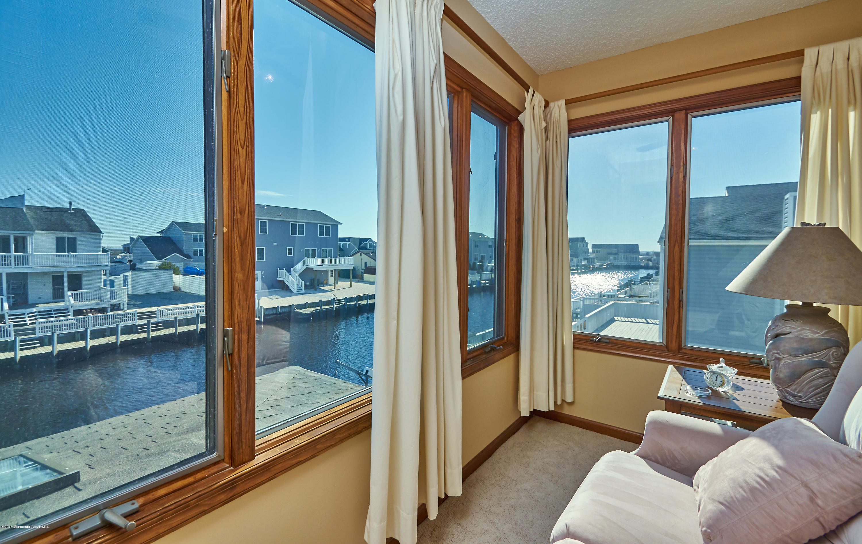 132 Peter Road Manahawkin, NJ 08050 - Photo 28 of 36 a balcony with furniture and a floor to ceiling window