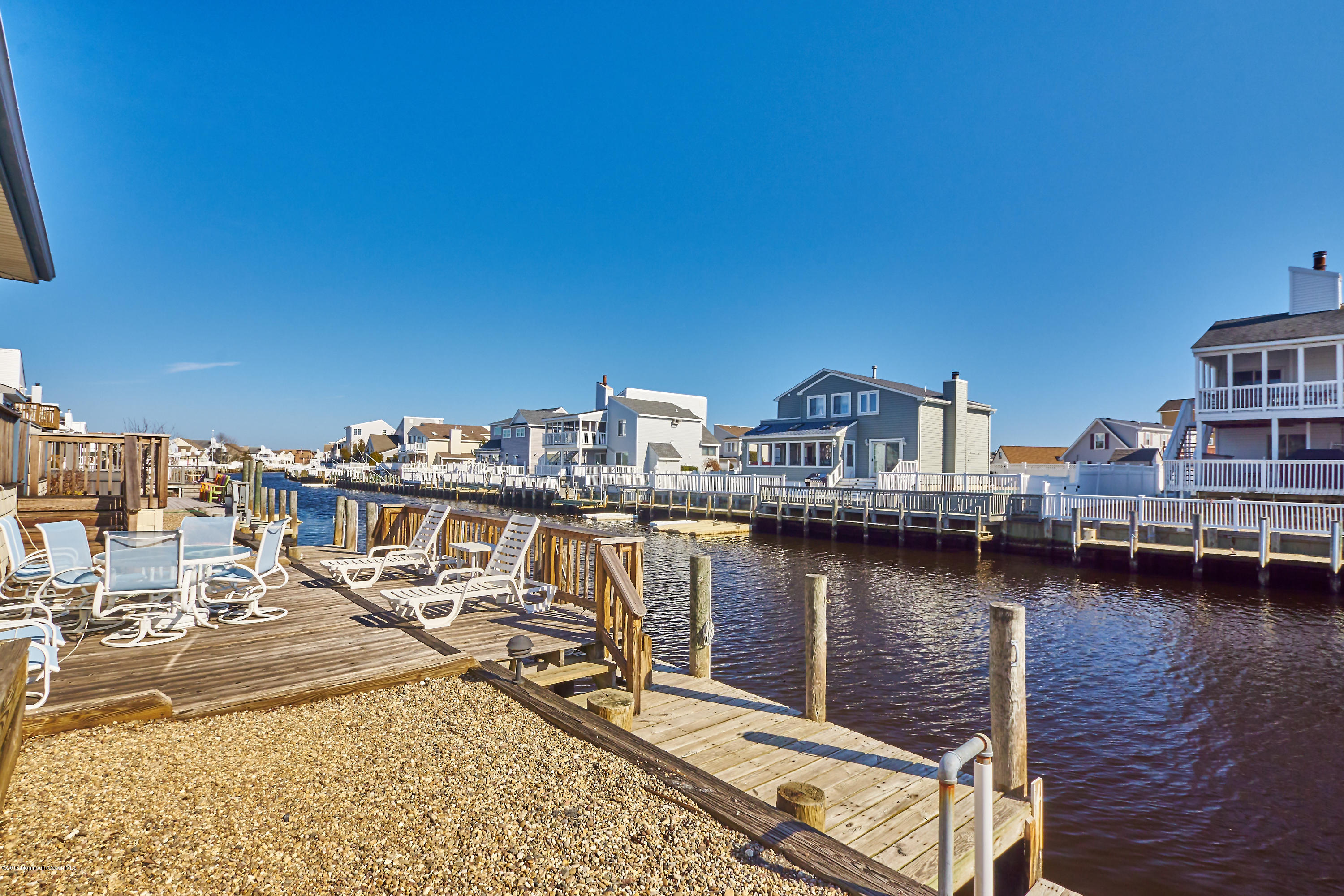 132 Peter Road Manahawkin, NJ 08050 - Photo 34 of 36 a view of a ocean with boats and trees in the background