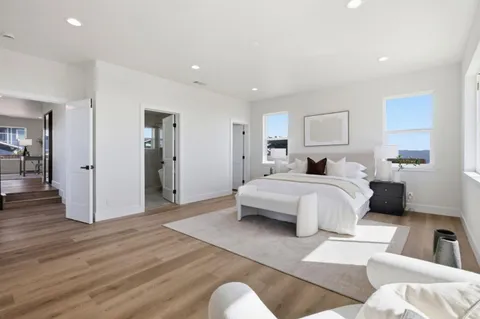 a bedroom with a bed and a couch