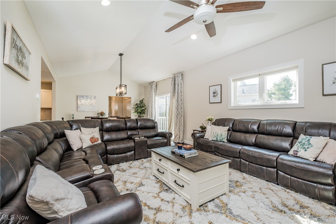 1365 Cascade Circle West Canton, OH 44708 - Photo 12 of 31 Carpeted living room with lofted ceiling, ceiling fan, and plenty of natural light