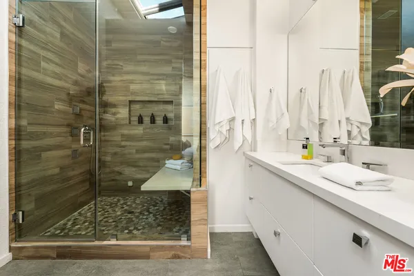 a bathroom with a shower and a sink