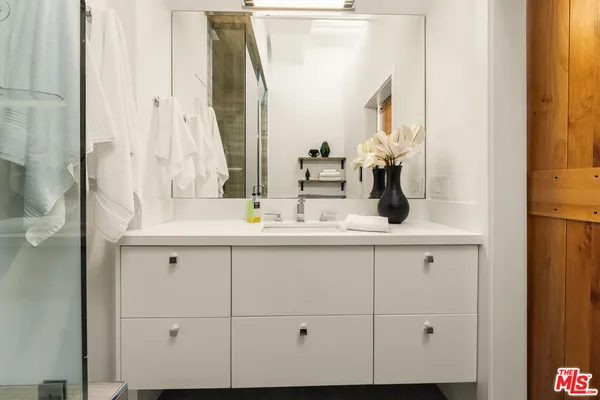 a bathroom with a sink and a mirror