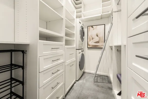 a view of walk in closet with empty racks