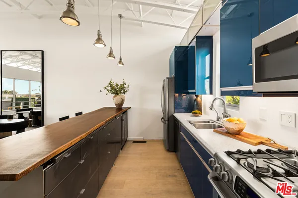 a kitchen with sink stove and cabinets