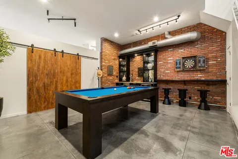 a room with pool table and furniture