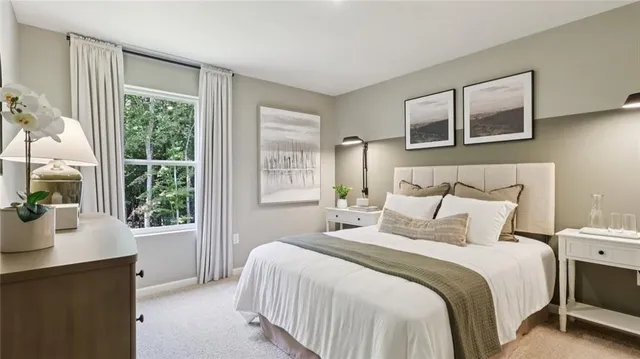 a bedroom with a large bed and a window