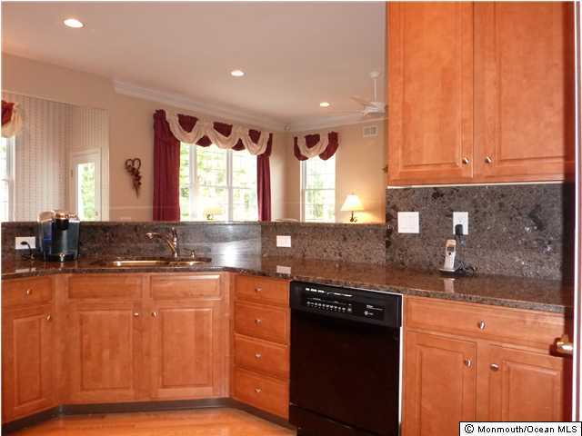 24 Winged Foot Road Jackson, NJ 08527 - Photo 3 of 3 a kitchen with granite countertop wooden cabinets and a sink