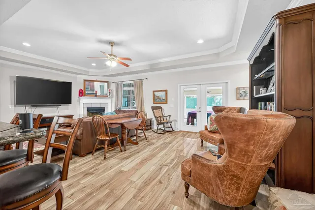 a living room with furniture a rug and a bookshelf
