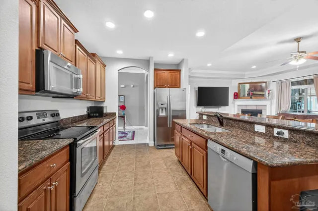 a kitchen with stainless steel appliances granite countertop a stove sink microwave and cabinets