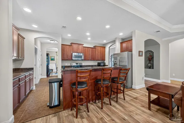 a bathroom with a granite countertop toilet sink and mirror