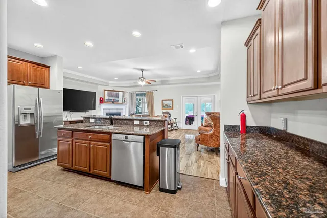 a bathroom with a granite countertop double vanity sink and a mirror