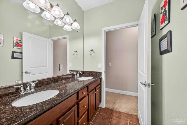 a bedroom with a bed and a lamp