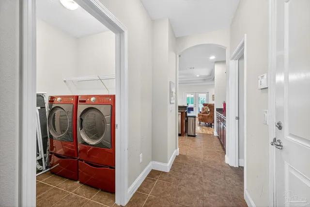 a view of a hallway and a livingroom with furniture