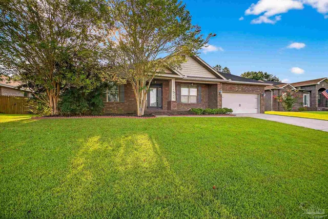 a front view of house with yard and green space