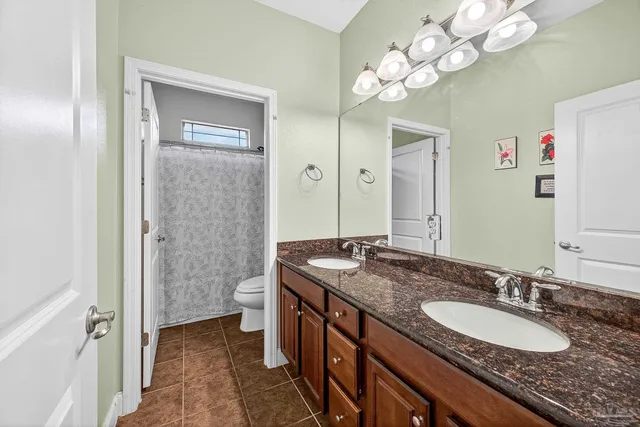 a hallway with two painting on the wall and a potted plant