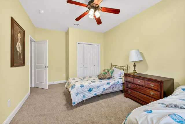 a bathroom with a granite countertop double vanity sink and a mirror