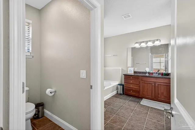 a view of an empty room with window and cabinet