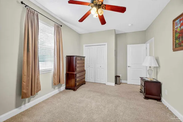 a view of a dining room with furniture and a chandelier