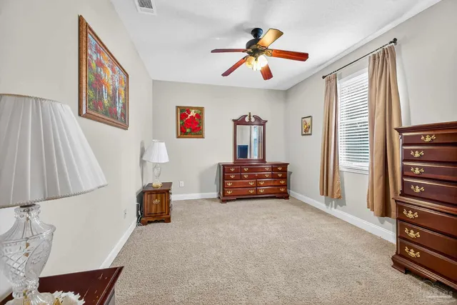 a view of a dining room with furniture and a potted plant