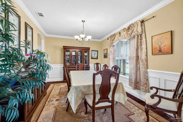 a view of a house with backyard sitting area and garden