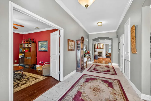a view of a hallway to a livingroom with furniture and wooden floor