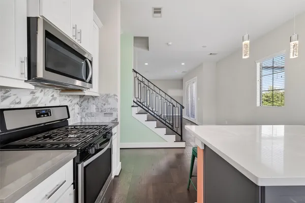 a kitchen with a stove and a microwave